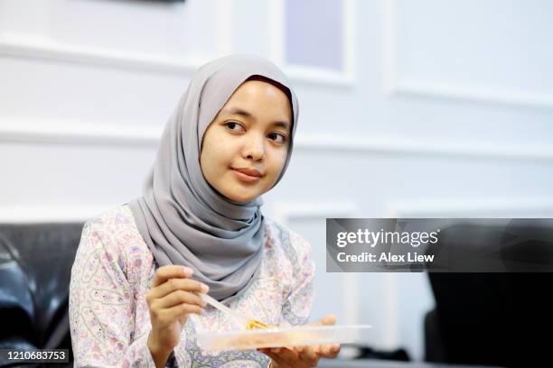 modern muslim women in malaysia - plastic cutlery stock pictures, royalty-free photos & images
