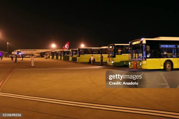 Turkish citizens arrive at the Adana airport after a plane of Turkey's national carrier Turkish Airlines, evacuated the 182 citizens stranded in...