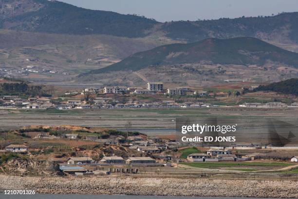 General view shows fields and buildings of the North Korean countryside outside Kaesong, seen across the Demilitarized Zone from the South Korean...
