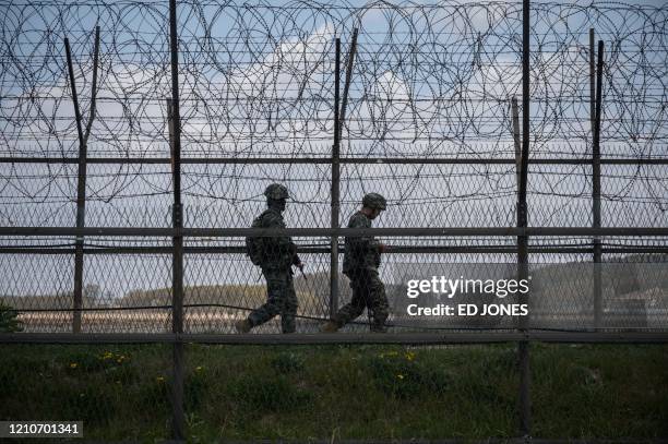 South Korean soldiers patrol along a barbed wire fence Demilitarized Zone separating North and South Korea, on the South Korean island of Ganghwa on...