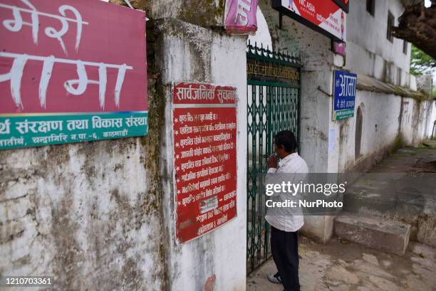 Nepalese devotee offering rituals from outside in the Matatritha Temple, a Hindus pilgrimage sites during annual festival of Mother's Day celebration...