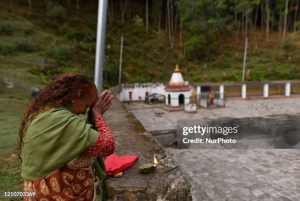 Nepalese devotee offering rituals from outside in the Matatritha Temple, a Hindus pilgrimage sites during annual festival of Mother's Day celebration...