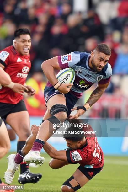 Lukhan Salakaia-Loto of the Reds is tackled by Richie Mo'unga of the Crusaders during the round six Super Rugby match between the Crusaders and the...