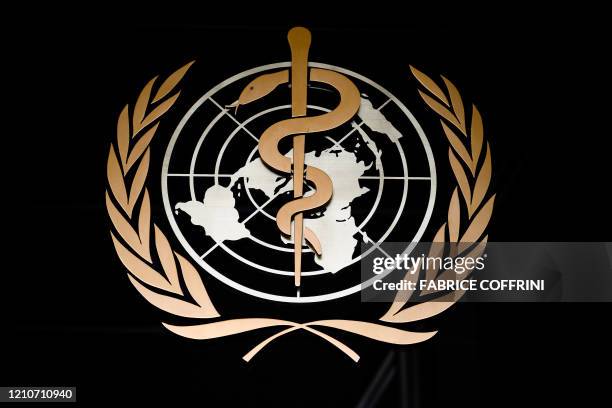 Picture taken on March 9, 2020 shows the logo of the World Health Organization at the entrance of their headquarters in Geneva, amid the COVID-19...