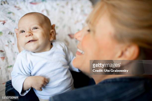 In this photo illustration a baby gives her mother a smile on April 21, 2020 in Bonn, Germany.