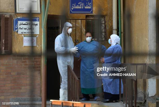Members of the medical staff at the infectious diseases unit of the Imbaba hospital in the capital Cairo, gather for a break on April 19 during the...