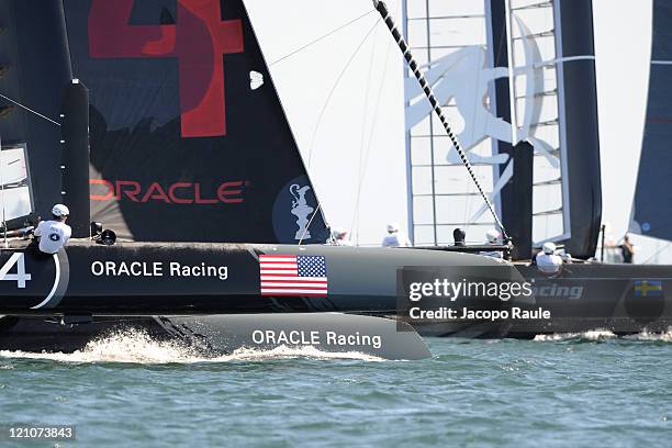 Two AC45 catamarans of team Oracle and team Artemis Racing compete in the Match Race Championship during the sixth day of the America's Cup World...