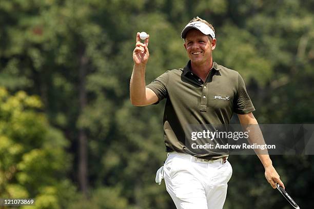 Luke Donald waves to the gallery after a birdie on the 14th hole during the third round of the 93rd PGA Championship at the Atlanta Athletic Club on...