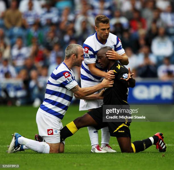 Shaun Derry of Queens Park Rangers clashes with Nigel Reo-Coker of Bolton during the Barclays Premier League match between Queens Park Rangers and...
