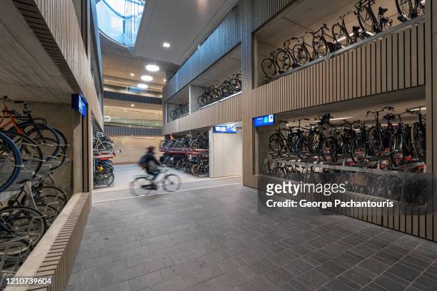 interior of the world's largest bicycle parking garage in utrecht, holland - utrecht stock pictures, royalty-free photos & images