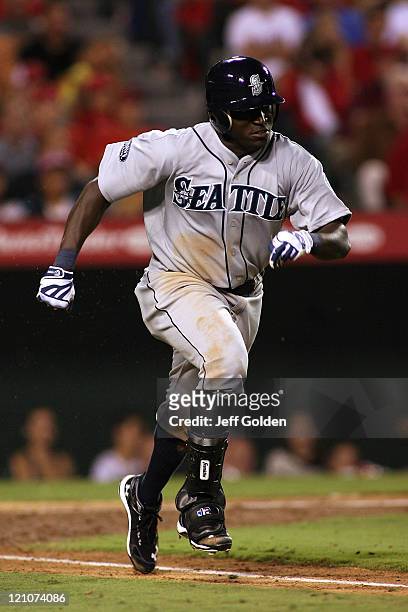 Trayvon Robinson of the Seattle Mariners makes his third plate appearance in his Major League debut as he runs to first base while grounding into a...