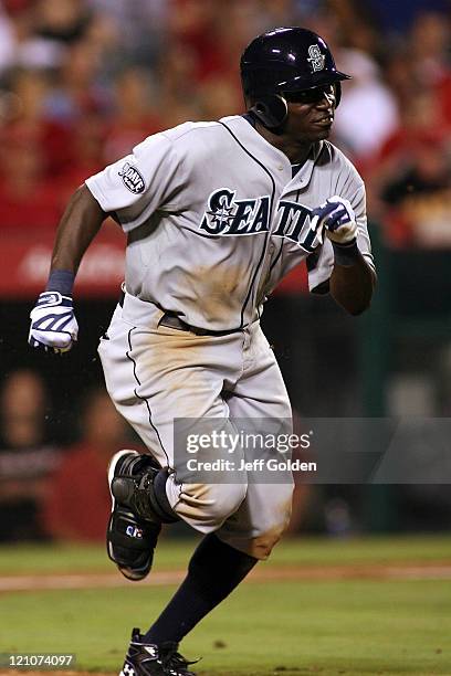 Trayvon Robinson of the Seattle Mariners makes his third plate appearance in his Major League debut as he runs to first base while grounding into a...