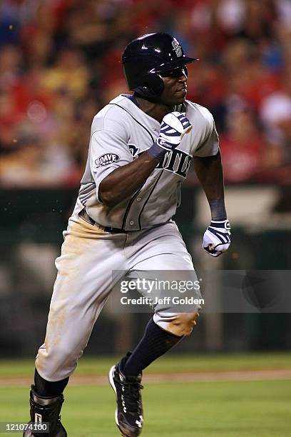 Trayvon Robinson of the Seattle Mariners makes his third plate appearance in his Major League debut as he runs to first base while grounding into a...