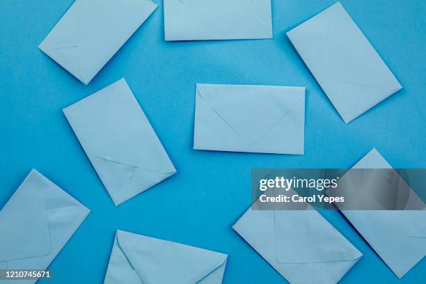 blue   envelopes in blue background.top view - yellow envelope stock pictures, royalty-free photos & images