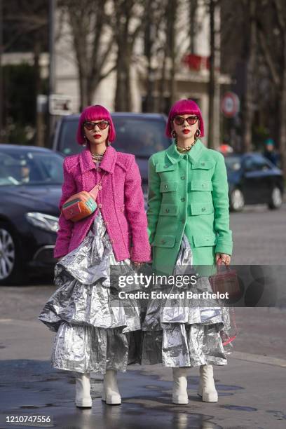 Fashion twins Ami and Aya are seen ; a guest wears sunglasses, a pink tweed jacket, an orange quilted belt bag from Chanel, a silver ruffled shiny...