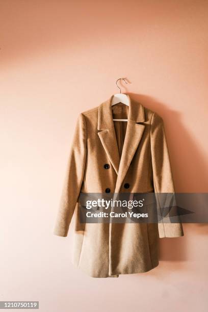 brown coat in a  hanger at home - anorak fotografías e imágenes de stock