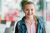 Confident teenage girl with braces, smiling at camera