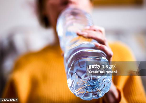 woman drinking mineral water from the bottle - glass bottle stock pictures, royalty-free photos & images