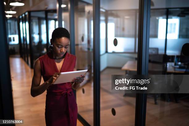 young businesswoman walking with digital tablet at coworking - woman business office ceo beauty stock pictures, royalty-free photos & images