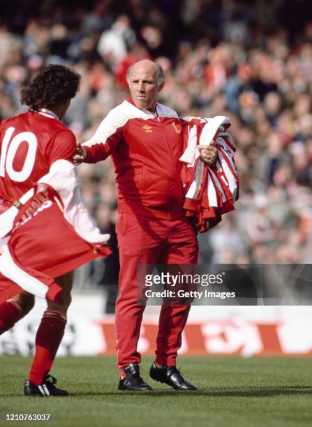 Liverpool trainer Ronnie Moran collects an Umbro tracksuit top from player Craig Johnston during the warm up before the 1983 League Cup Final against...