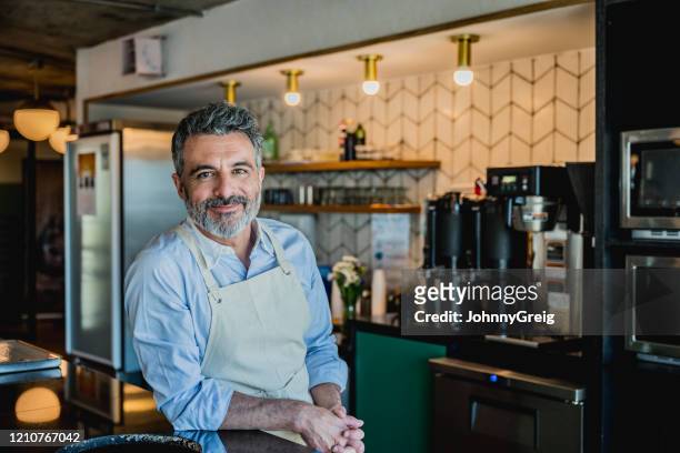 smiling male barista ready to prepare drink in coffee bar - small business stock pictures, royalty-free photos & images