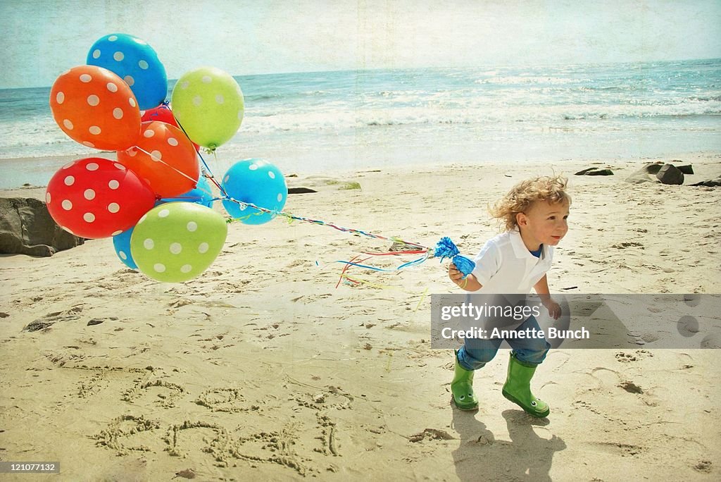 Boy running with balloons