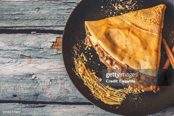 french pancake with cinnamon on plate - nutella pancake stock pictures, royalty-free photos & images