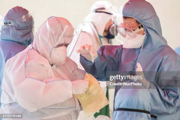 Health workers take a sample in order to perform a COVID-19 test on April 23, 2020 in Sofia. Free antibody and COVID-19 testing at the entrance to...