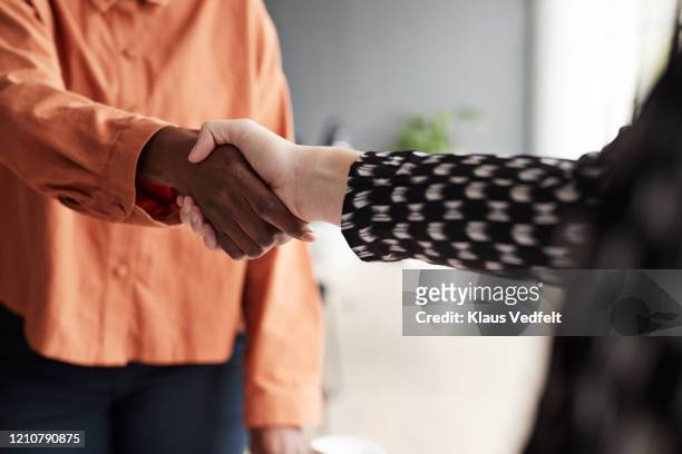business executives shaking hands at workplace - handshake stock pictures, royalty-free photos & images