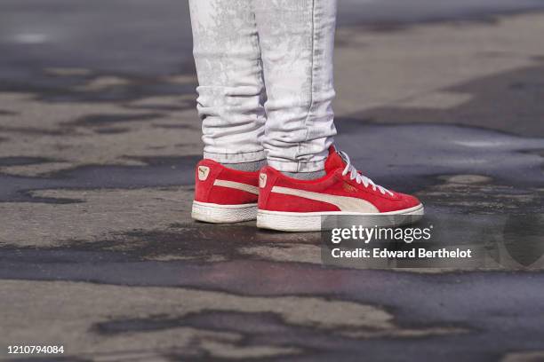 Puma red sneakers are seen, outside Chanel, during Paris Fashion Week - Womenswear Fall/Winter 2020/2021 on March 03, 2020 in Paris, France.