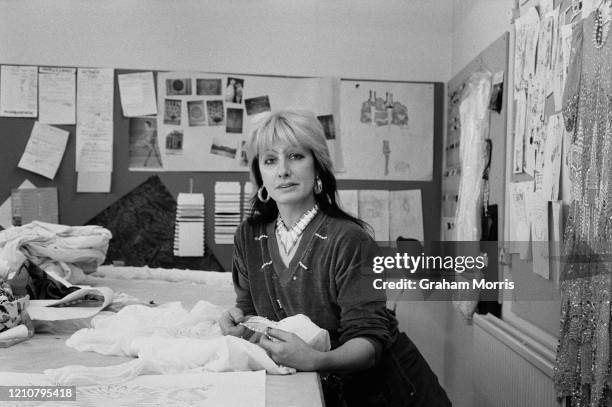 British fashion and textile designer Zandra Rhodes in her studio, fabrics and drawings on the pin boards in the background, in London, England, 9th...