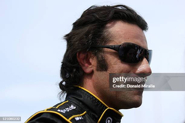 Dario Franchitti, driver of the Nikon Target Chip Ganassi Racing, looks on from the pits after qualifying with the pole position during the IZOD...