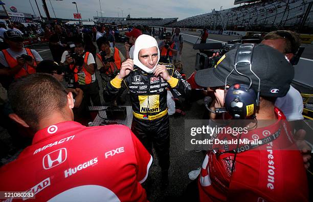 Dario Franchitti, driver of the Nikon Target Chip Ganassi Racing, speaks to his crew in the pits after qualifying with the pole position during the...