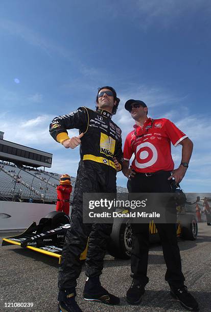 Dario Franchitti, driver of the Nikon Target Chip Ganassi Racing, speaks to his crew in the pits after qualifying with the pole position during the...