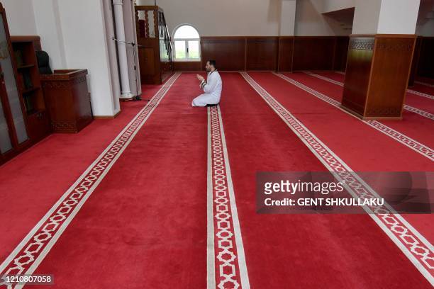 Xhemal Hafizi, Imam of the Tanners' Mosque, prays alone on the first night of the holy month of Ramadan, in Tirana on April 23, 2020 during a...