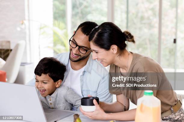 young family watch program on laptop - military spouse stock pictures, royalty-free photos & images