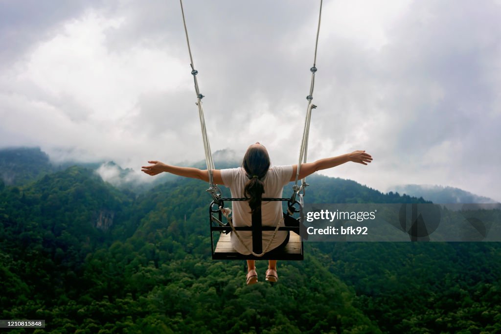 Female on Swing in the mountains.