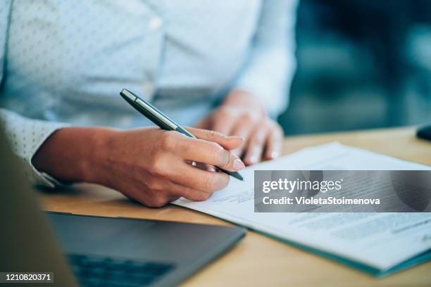 businesswoman checking agreement before signing. - documento imagens e fotografias de stock