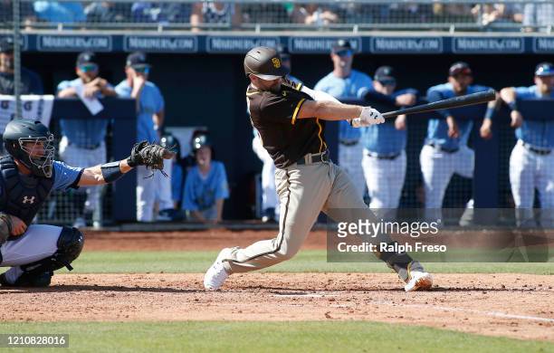 Brian Dozier of the San Diego Padres swings during an at-bat against the Seattle Mariners in a Cactus League spring training baseball game at Peoria...