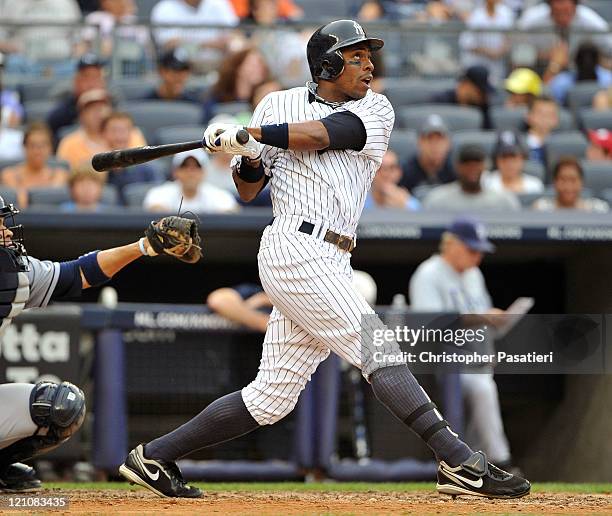 Curtis Granderson of the New York Yankees watches his solo home run to lead off the bottom of the fifth inning against the Tampa Bay Rays at Yankee...