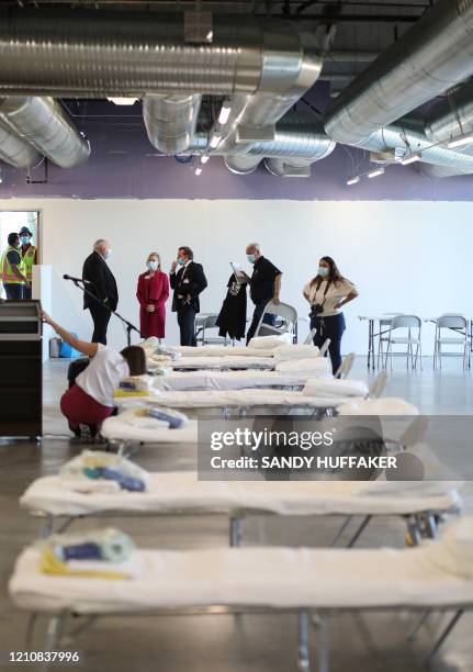 Hospital officials stand during a tour of a new Federal Medical Station at Palomar Hospital in Escondido, California on April 23, 2020. - The FEMA...