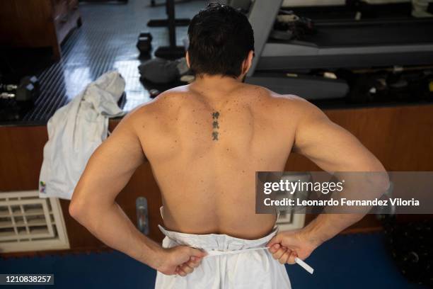 Venezuelan Karateka Antonio Jose Diaz Fernandez dresses in the pants called zubon of his karategi before training and giving his karate class from...