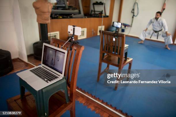 Venezuelan Karateka Antonio Jose Diaz Fernandez teaches online karate lessons from his dojo during COVID-19 lockdown on April 23, 2020 in Caracas,...