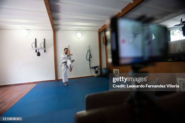 Venezuelan Karateka Antonio Jose Diaz Fernandez teaches online karate lessons from his dojo during COVID-19 lockdown on April 23, 2020 in Caracas,...