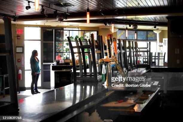 Asia Mei, owner of Moonshine 152, poses in her restaurant, which has been shut down due to COVID-19, on April 22, 2020. Her corner bar and food...