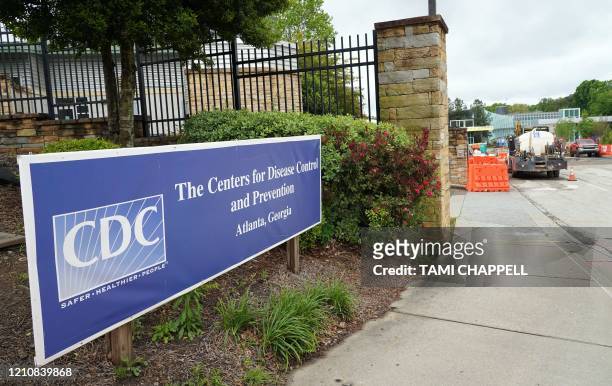 Sign is seen by the entrance of the Centers for Disease Control and Prevention in Atlanta, Georgia on April 23, 2020. - The worldwide death toll from...