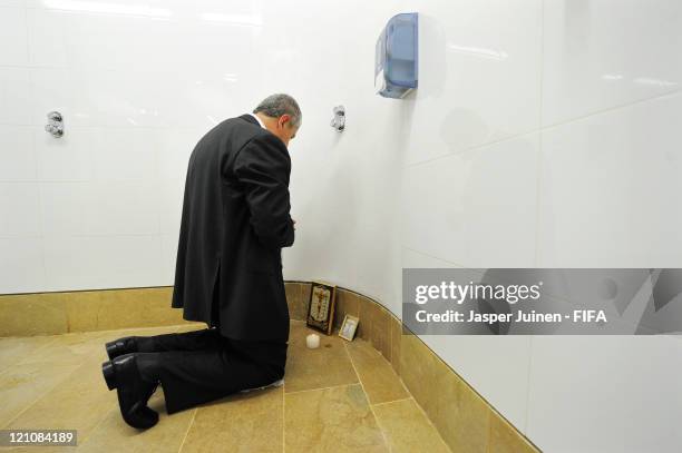 Head coach Eduardo Lara of Colombia prays after lighting a candle in the shower aeria of his team's dressing room prior to the FIFA U-20 World Cup...