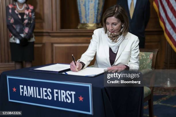 House Speaker Nancy Pelosi, a Democrat from California, signs H.R. 266, The Paycheck Protection Program and Health Care Enhancement Act, during a...