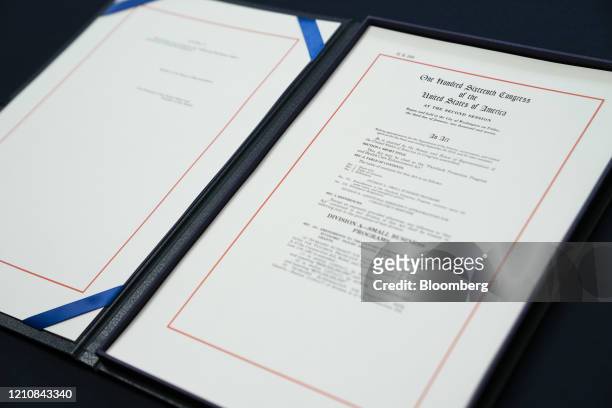 Copy of H.R. 266, The Paycheck Protection Program and Health Care Enhancement Act, is seen before it is signed in the Rayburn Room of the U.S....