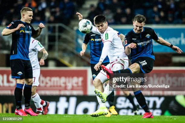 Jorge Mere of Köln challanges Dennis Srbeny of Paderborn during the Bundesliga match between SC Paderborn 07 and 1. FC Köln at Benteler Arena on...